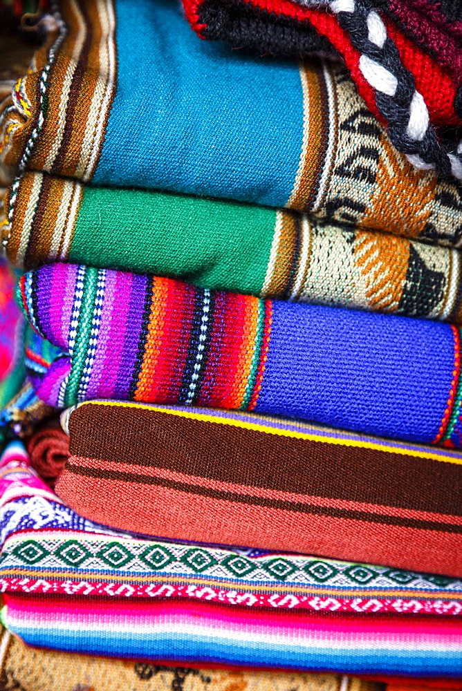 Colorful carpets made of llama and alpaca wool for sale at San Pedro market, Cuzco, Peru.