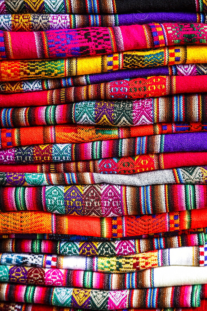 Colorful carpets made of llama and alpaca wool for sale at San Pedro market, Cuzco, Peru.