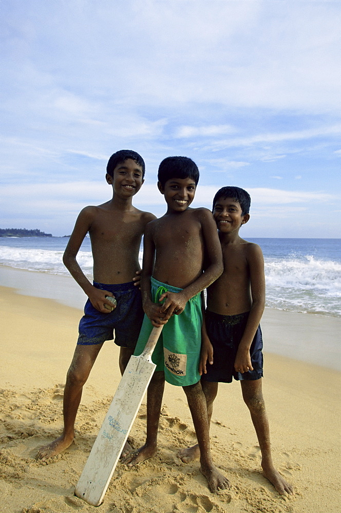 Boys playing cricket, Hikkaduwa beach, Sri Lanka, Asia