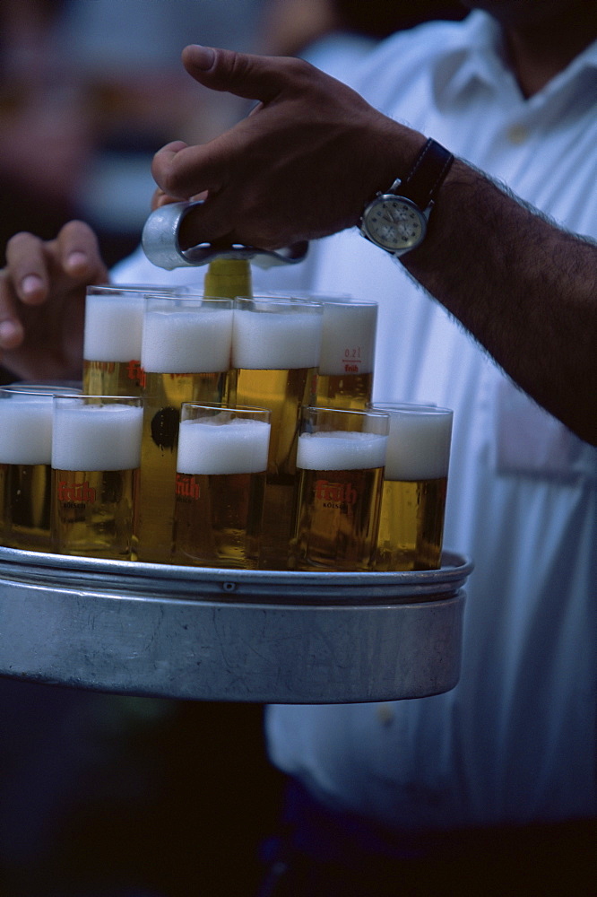 Close up of the locally produced beer called Kolsch, served in traditional Stangen glasses, outside the Fruh Am Dom, Beer Hall in the Old Town (Altstadt), Cologne, North Rhine Westphalia, Germany, Europe