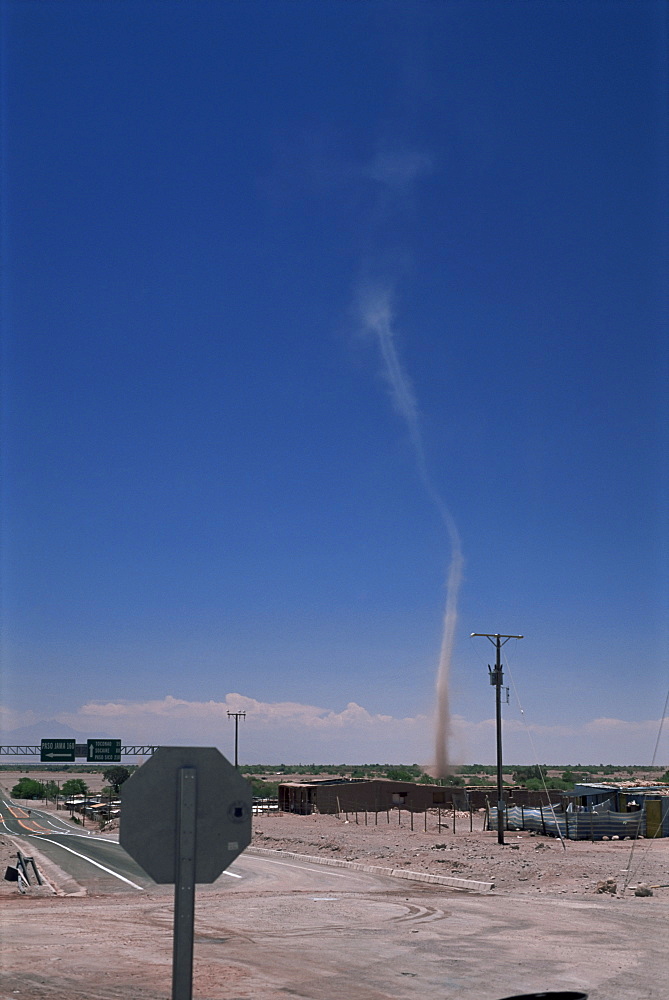 Mini twister (dust devil) forms above town, San Pedro de Atacama, Chile, South America