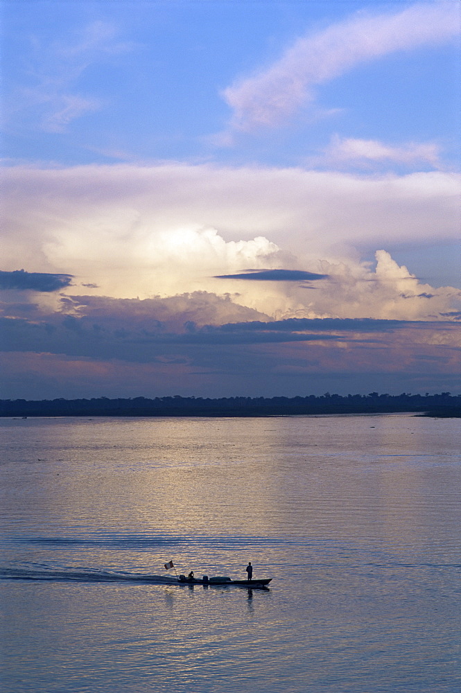 Small fishing boat moving down giant river, Amazon River, Peru, South America