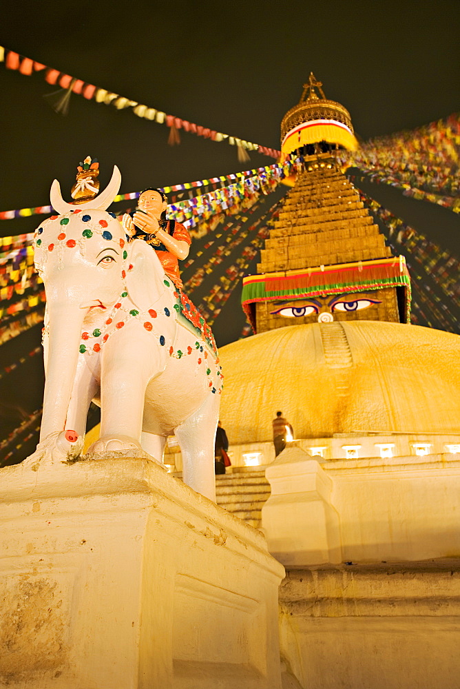 Tibetan Buddhist stupa, Boudha, Bodhnath, lit by votive candles on a winter night, Kathmandu, Nepal, Asia