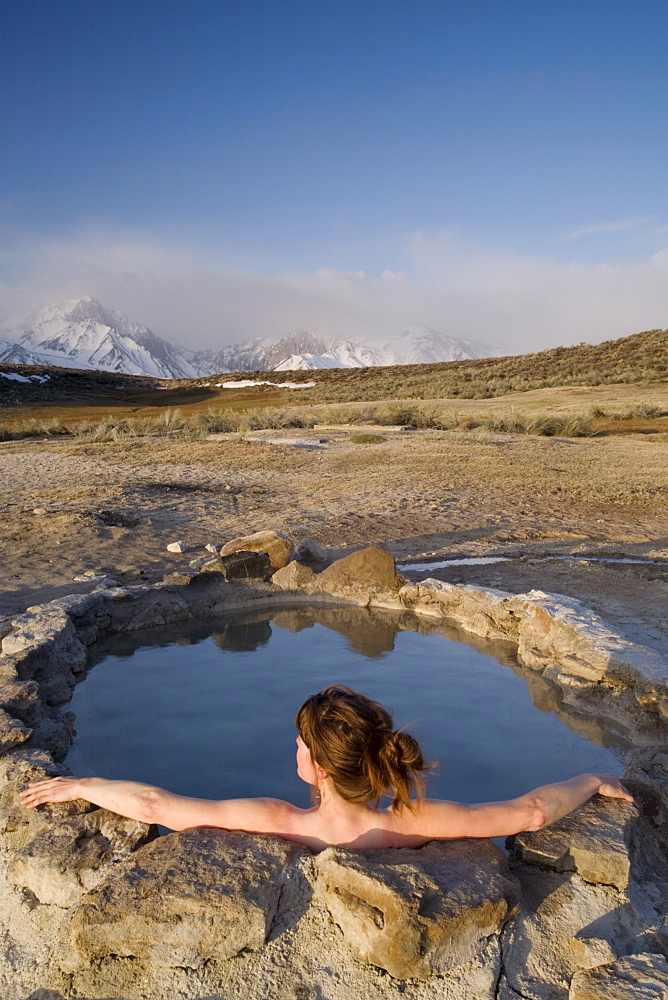 Woman relaxing in hot spring, Mammoth Lakes region, California, United States of America, North America