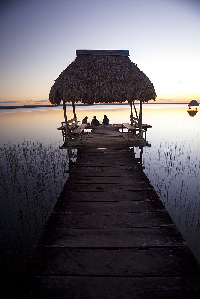 People relaxing at sunset, Lago Peten Itza, El Remate, Guatemala, Central America