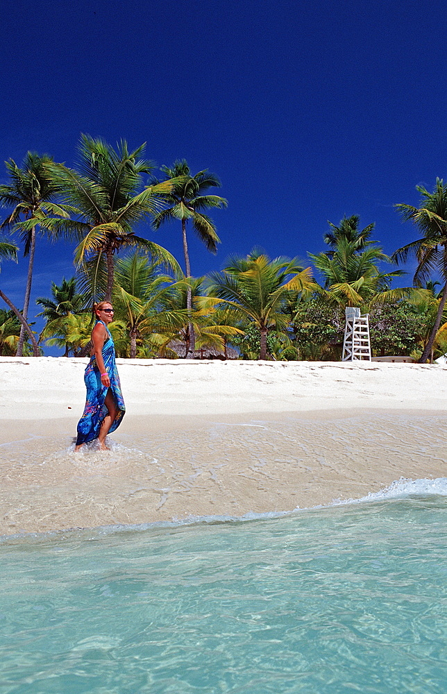 Woman walking on sandy beach, Catalina Island, Dominican Republic, West Indies, Caribbean, Central America