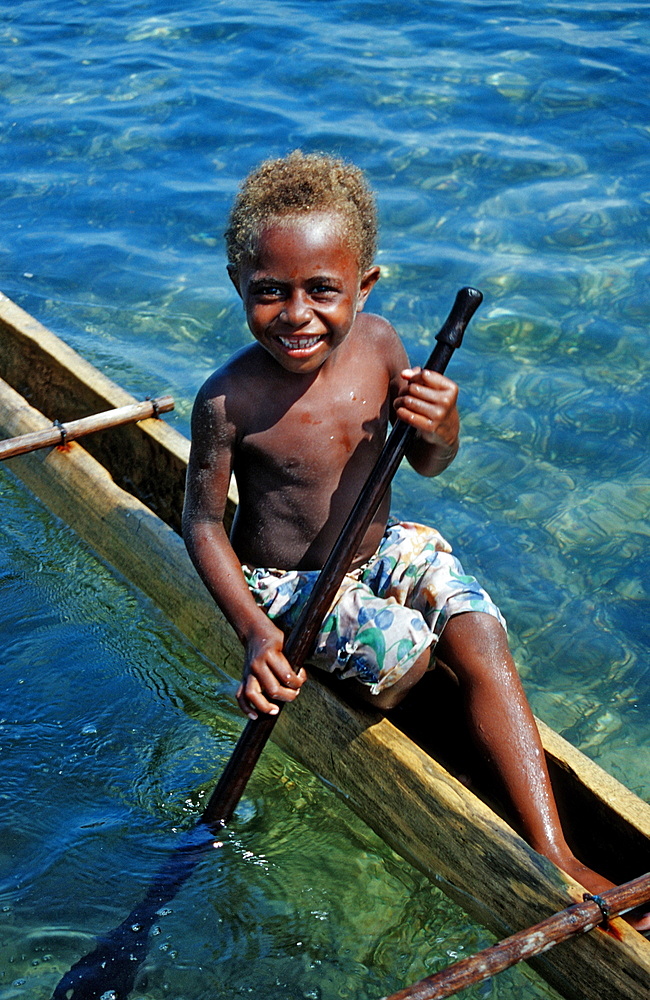 Childs in an Outrigger boat, Papua New Guinea, New Ireland, Kavieng