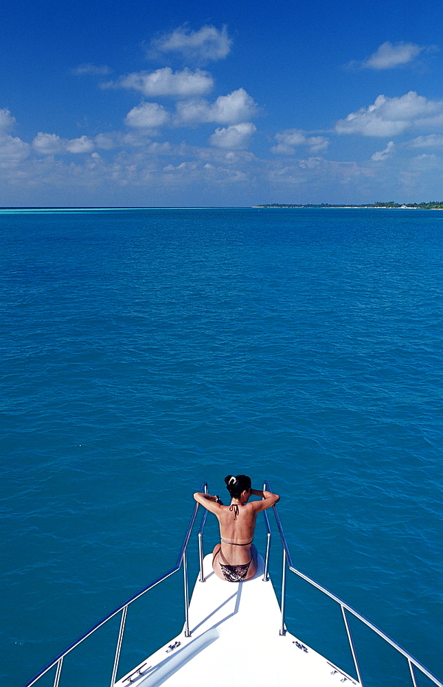 Tourist sitting on Bow, Maldives, Indian Ocean, Medhufushi, Meemu Atoll