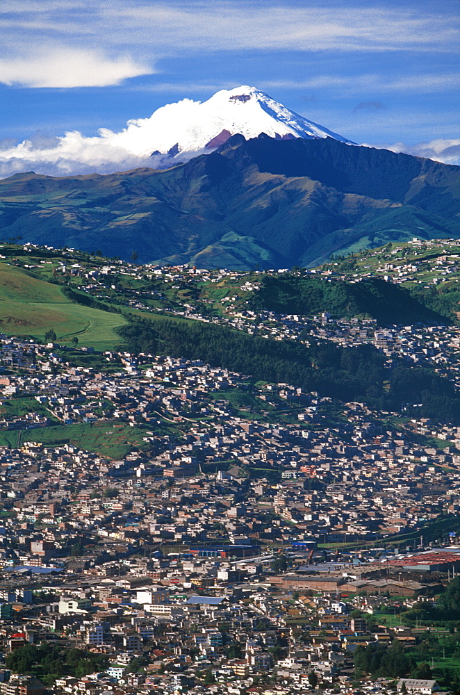 Ecuador's capital and second largest city a view of Quito with Cotopaxi, at 5900 meters, 19,350ft the world's highest active volcano, Quito, Ecuador