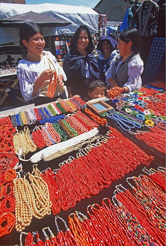 Otavalo, north of Quito is one of Latin Am's most famous markets for textiles, crafts and produce Otavalo women buying necklaces, Quito, Ecuador