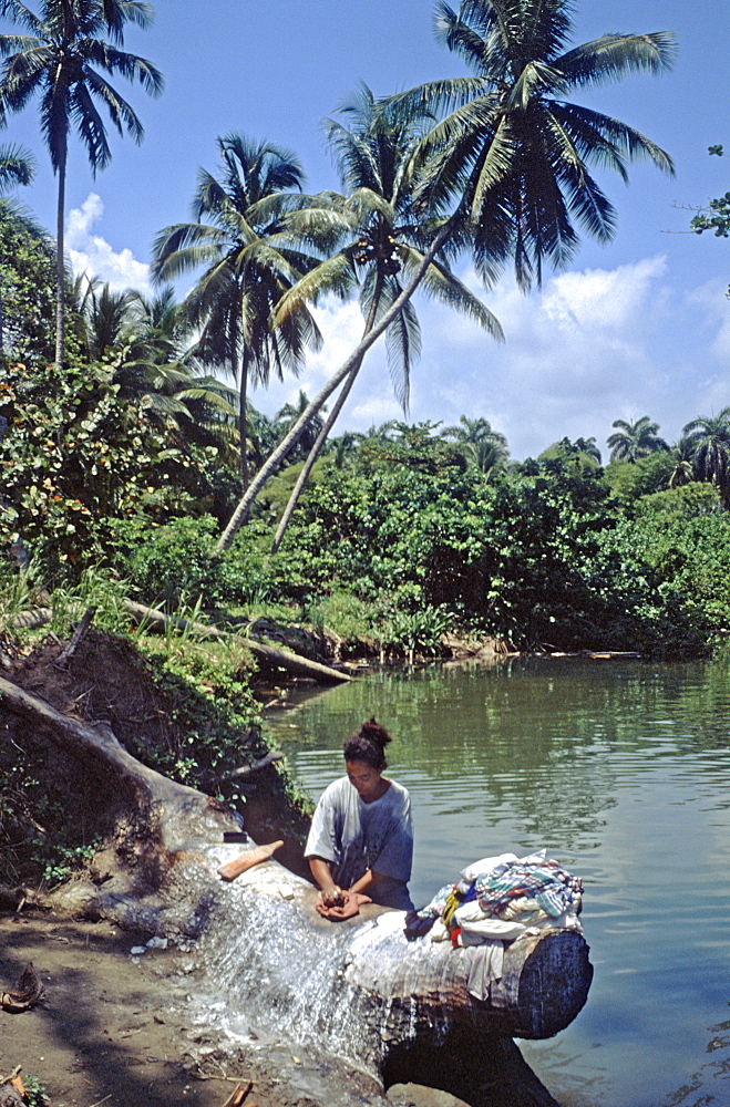 A woman washing clothes in the Rio Duaba near the town of Baracoa in eastern Cuba, Cuba