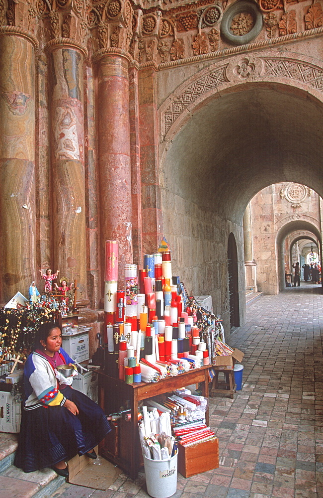 Cuenca World Heritage City & Ecuador's third largest city, famous for its colonial architecture woman selling religious items in Cathedral, Highlands, Ecuador