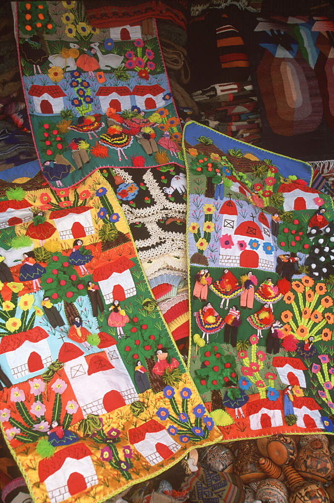 Appliqued village scenes are examples of the varied folkart to be found in the handicraft market in Miraflores, Lima, Peru