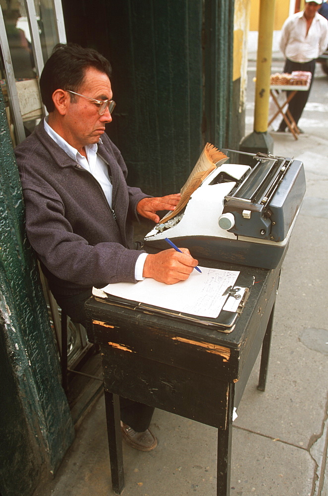 A colonial city with an attractive Plaza de Armas in the heart of the city public typist with typewriter at desk on sidewalk, Trujillo, North Coast, Peru