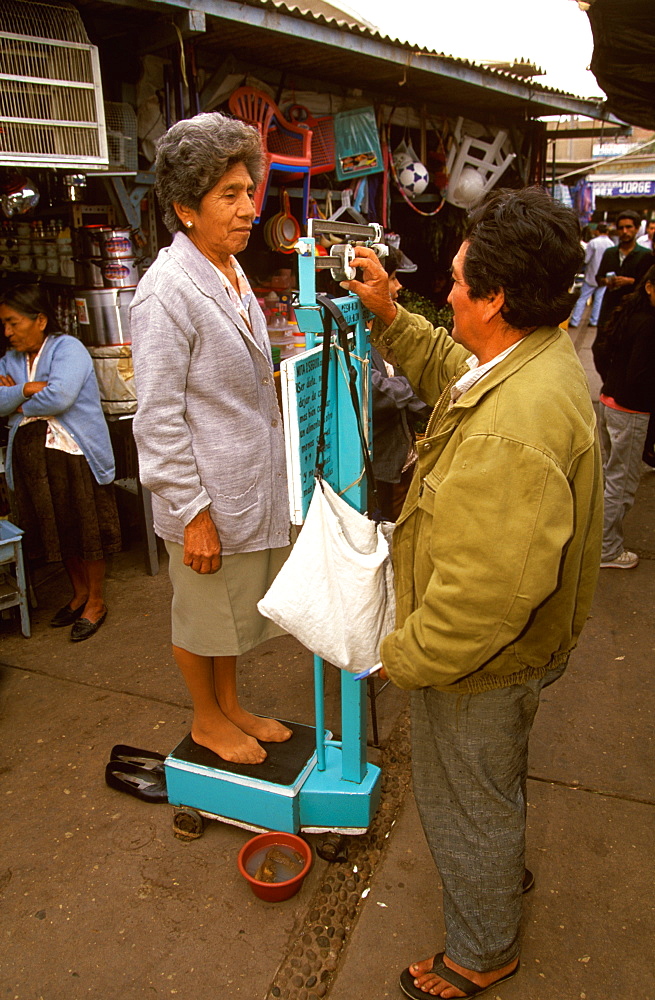 Chiclayo Mercado de Brujos or Witchcraft Market with many choices of herbal medicines, potions and charms a public scale with customer, North Coast, Peru