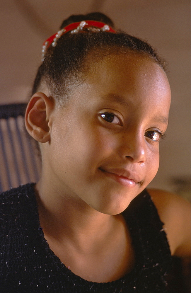 Portrait of a young Cuban girl in her home in La Serafina in the southern part of La Habana Province, Cuba