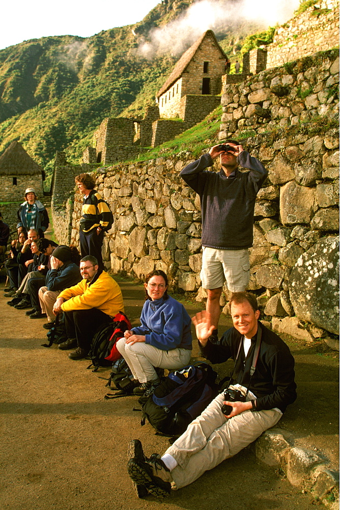 Machu Picchu tourist group with guide visiting the ancient city enormous numbers of tourists come to the site each year, Highlands, Peru