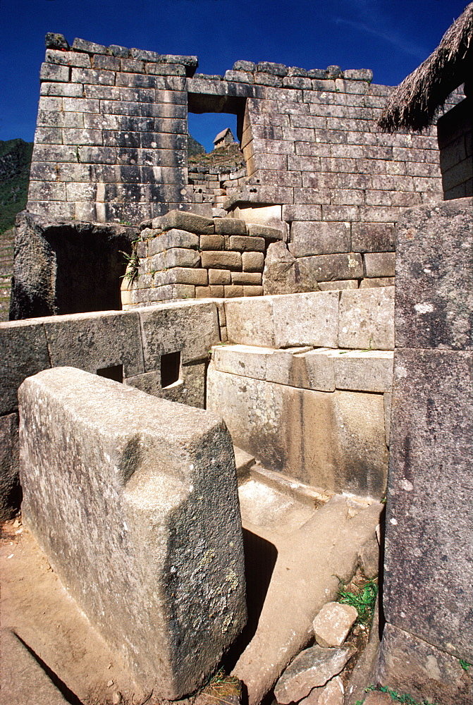 Machu Picchu skillfully carved, stone wall of the Sun Temple, with fountains and water channels in foreground, Highlands, Peru