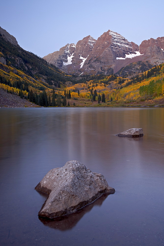 Maroon Bells at dawn with Maroon Lake in the fall, White River National Forest, Colorado, United States of America, North America