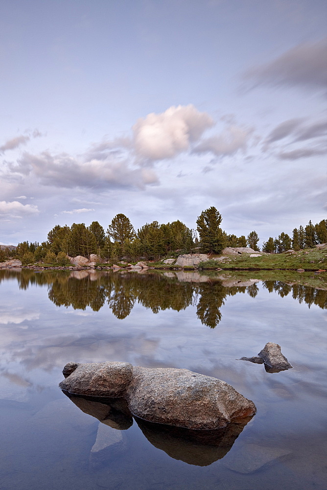 Clouds at sunset reflected in an unnamed lake, Shoshone National Forest, Wyoming, United States of America, North America