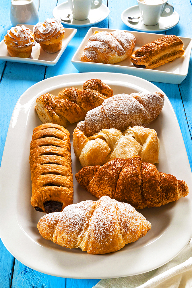 Italian breakfast with pastries, croissant, puff pastry (sfoglia) with chocolate, puff pastry (sfoglia) with cream, rice puddings (budini di riso) and espresso, Italy, Europe