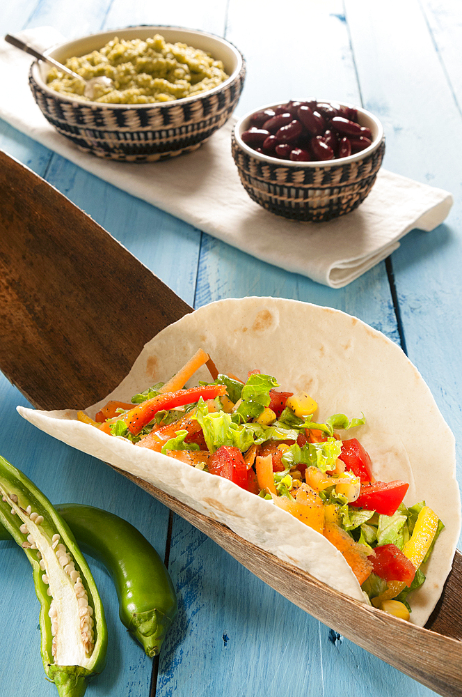 Vegetarian Taco in flour Tortilla with guacamole, hot green peppers and beans, Mexico, North America