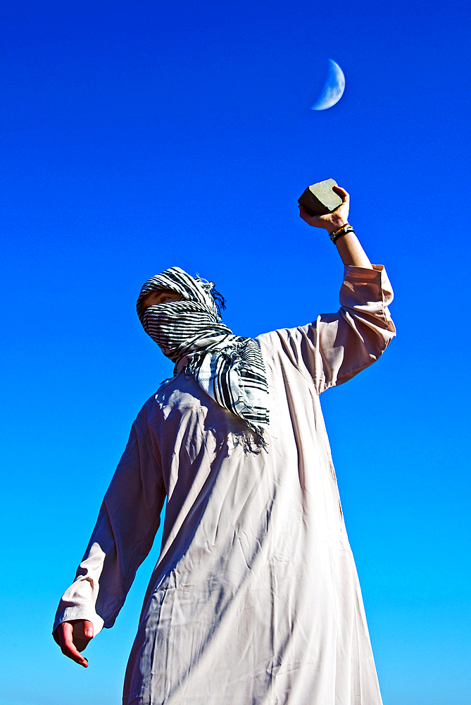 Arab protester throws stone during clashes, Florence, Tuscany, Italy, Europe