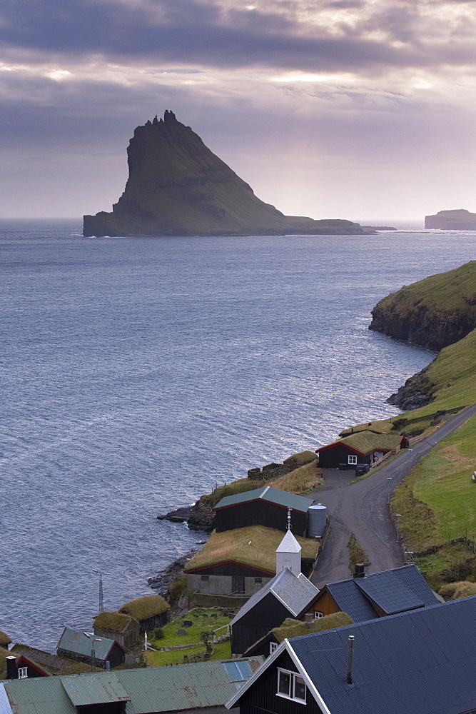 Village of Bour and Tindholmur island rising to 262m, at sunset from Vagar, Faroe Islands (Faroes), Denmark, Europe