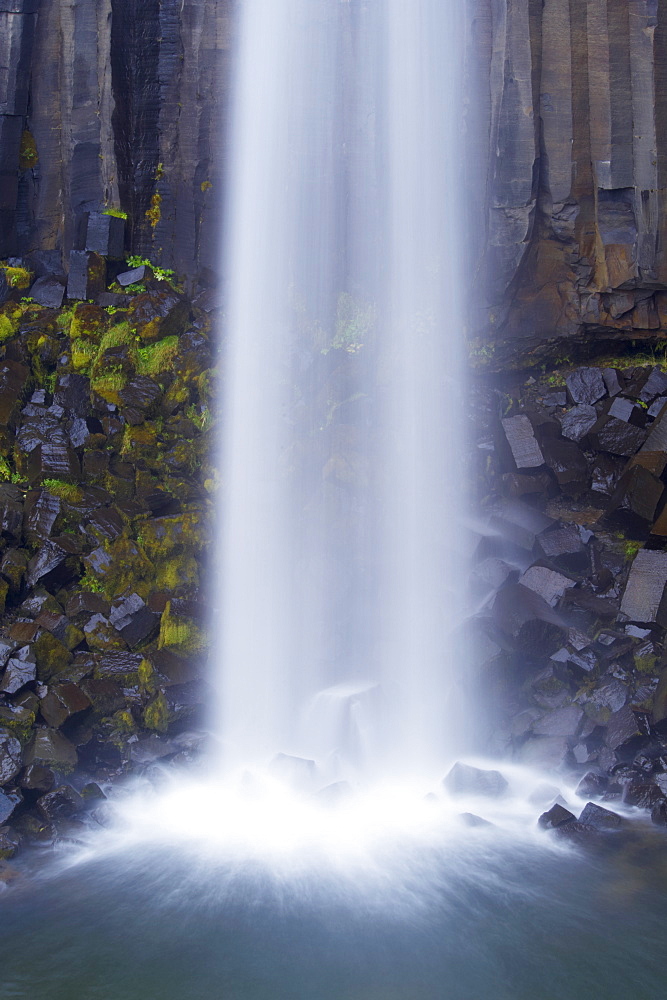 Water tumbling upon black basalt columns at famous Svartifoss waterfall in Skaftafell National Park, south-east Iceland (Austurland), Iceland, Polar Regions