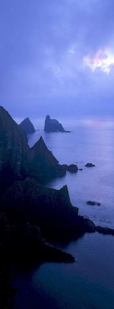 North cliffs and stack of Skroo in the mist, Fair Isle, Shetland Islands, Scotland, United Kingdom, Europe