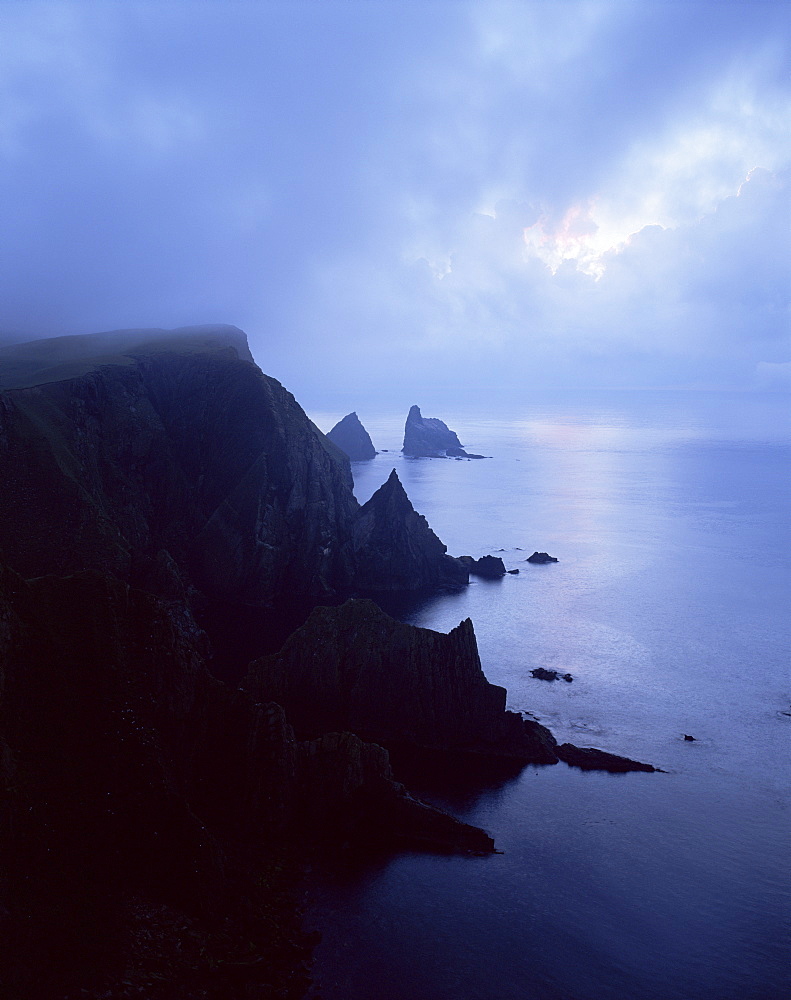 North coast of Fair Isle, with Stack of Skroo in mist in the distance, Fair Isle, Shetland Islands, Scotland, United Kingdom, Europe