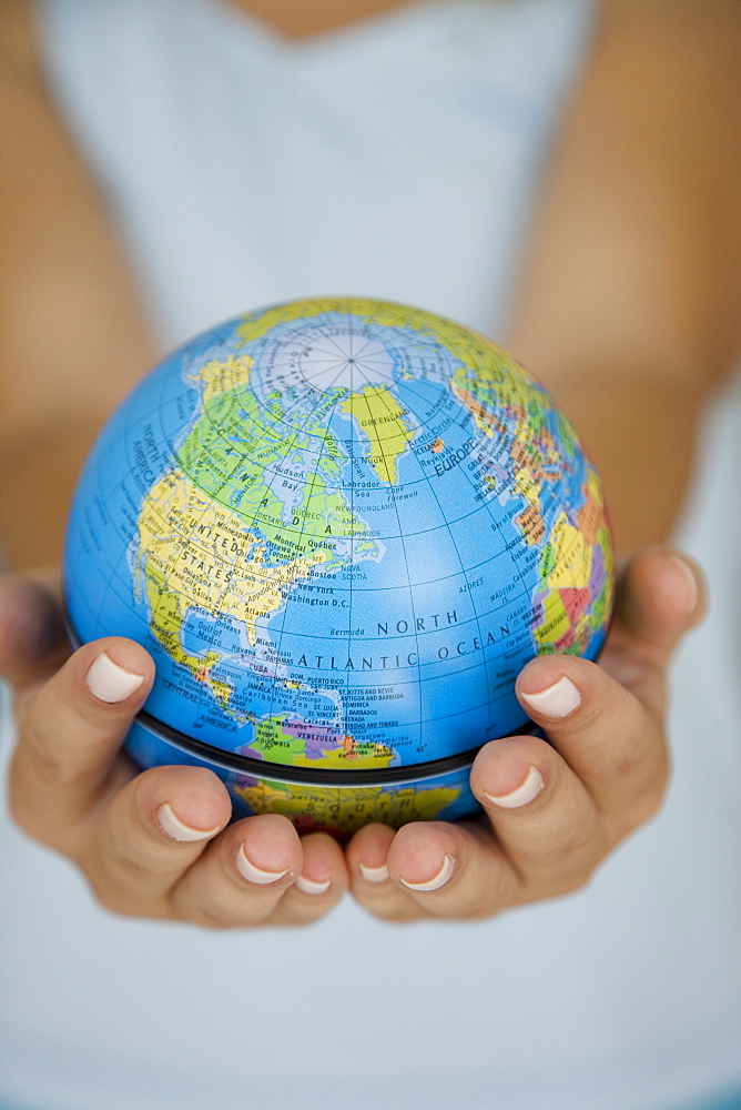 Woman's hands holding world globe