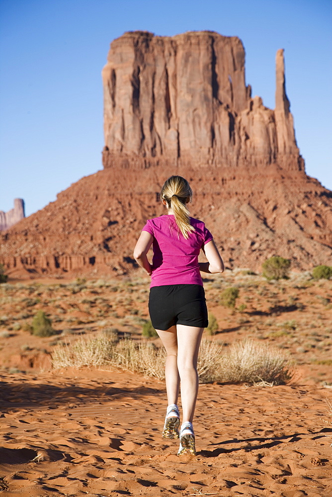 Woman jogging, Monument Valley Navajo Tribal Park, Utah Arizona border, United States of America, North America