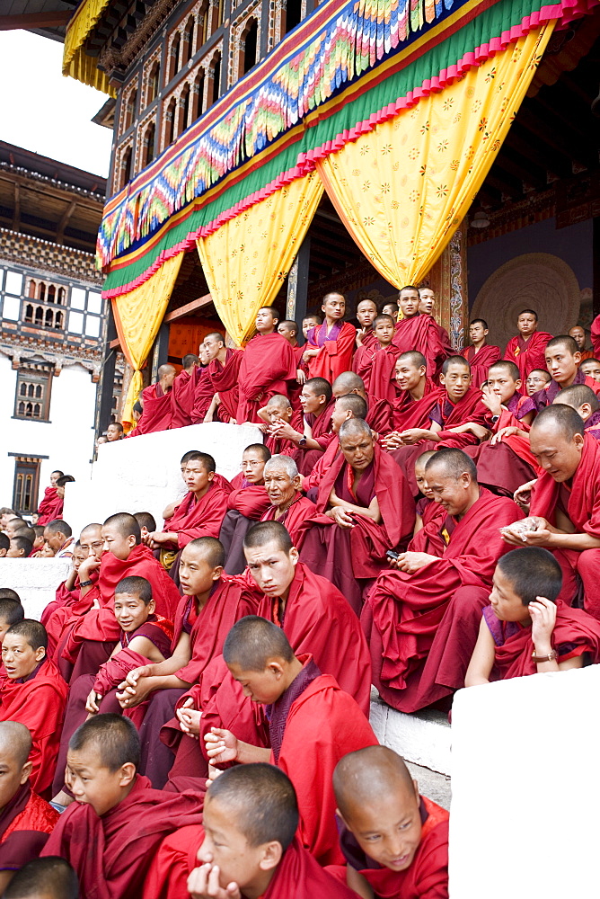 Monks watching religious dances, Buddhist festival (Tsechu), Trashi Chhoe Dzong, Thimphu, Bhutan, Asia