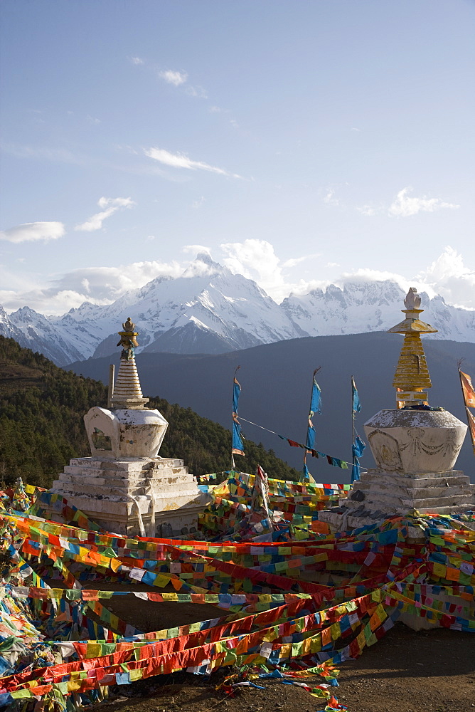 Buddhist stupas on way to Deqin, on the Tibetan Border, with the Meili Snow Mountain peak in the background, Dequin, Shangri-La region, Yunnan Province, China, Asia