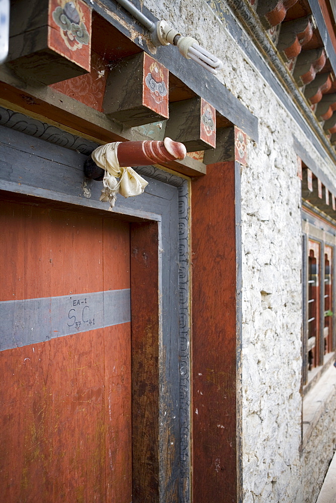 Phallus above house door to ward off evil spirits, Jankar, Bumthang Valley, Bhutan, Asia