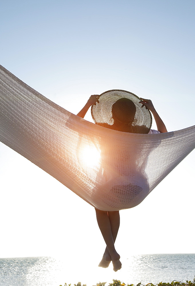 Woman in a hammock on the beach, Florida, United States of America, North America