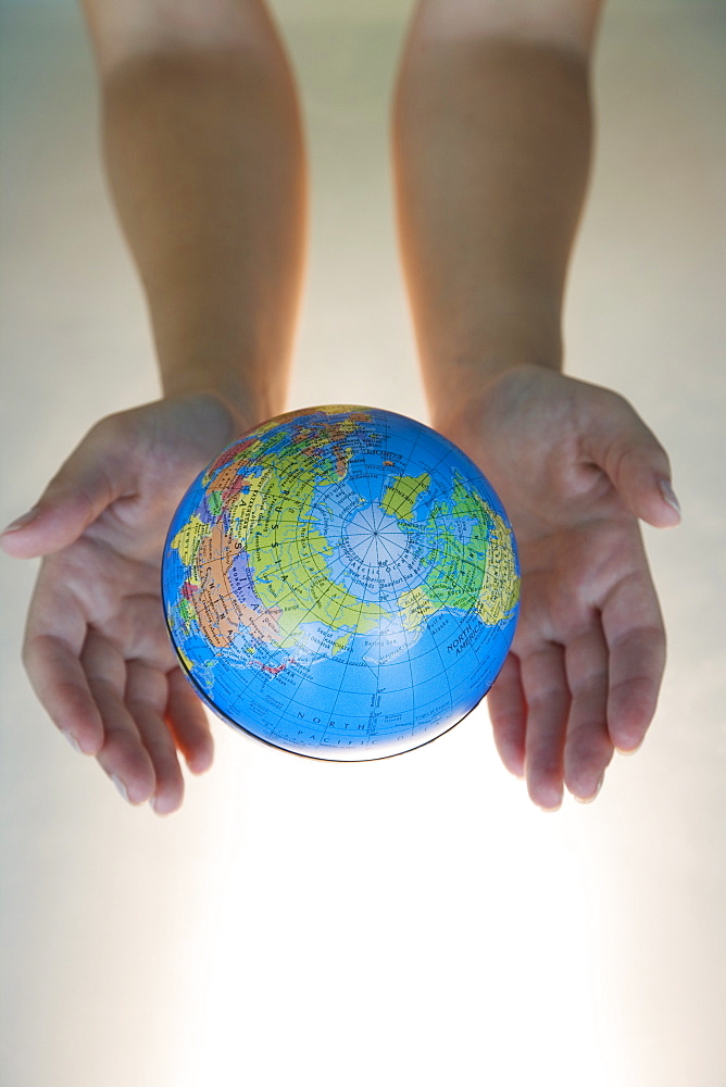 Woman's hands with world globe