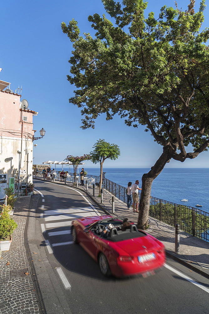 Red sport car on the narrow street of Amalfi Coast, UNESCO World Heritage Site, Campania, Italy, Europe