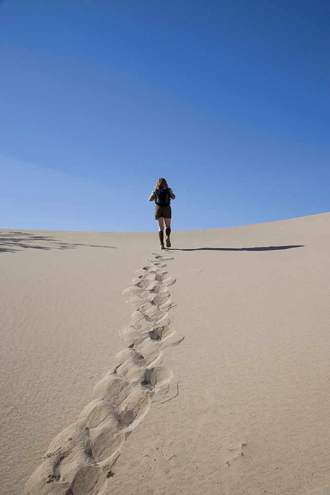 Woman trekking, Sand Dunes Point, Death Valley National Park, California, United States of America, North America