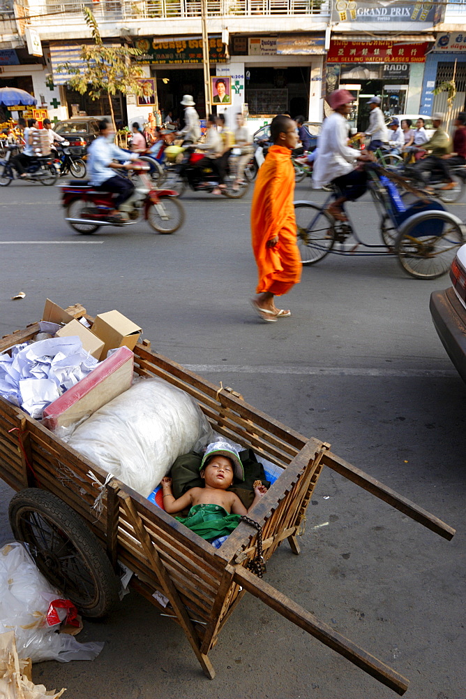 A small child sleeps in a cart on the streets of Phnom Penh, Cambodia, Indochina, Southeast Asia, Asia