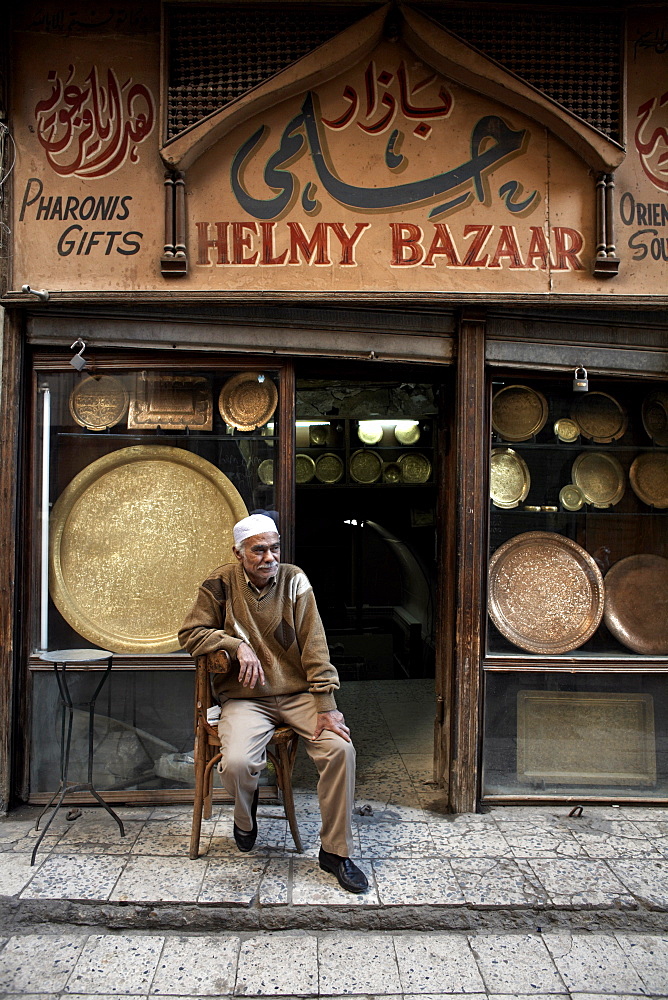 Shop owner relaxes in the great bazaar of Khan al-Khalili, Cairo, Egypt, Africa