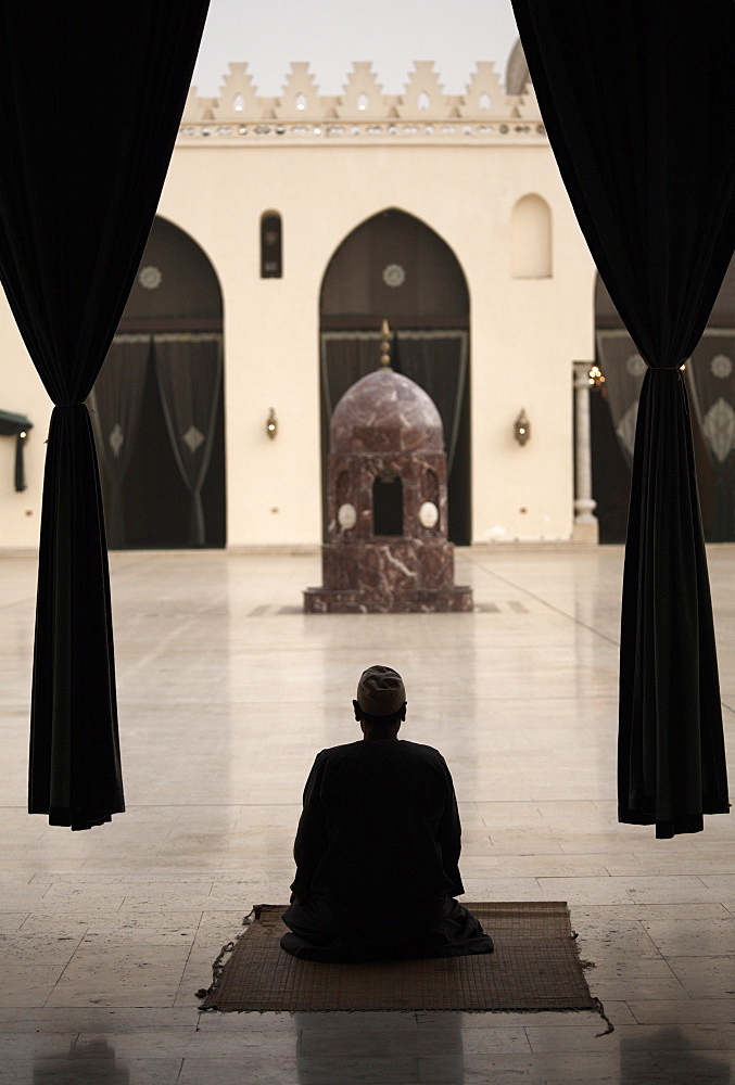 Man praying at the Mosque of Al-Hakim, Cairo, Egypt, North Africa, Africa