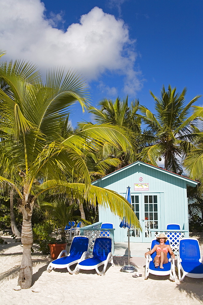 Beach cabana and woman, Princess Cays, Eleuthera Island, Bahamas, West Indies, Central America