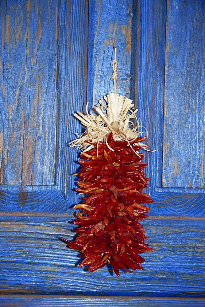 Chillies hanging on blue door, Mercado de la Mesilla, Las Cruces, southern New Mexico, United States of America, North America