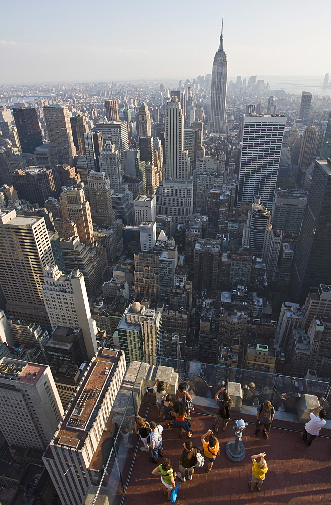 Tourists photographing view of the Empire State Building from the top of the General Electric Building, (Top of the Rock), Rockefeller Centre, Manhattan, New York, United States of America, North America