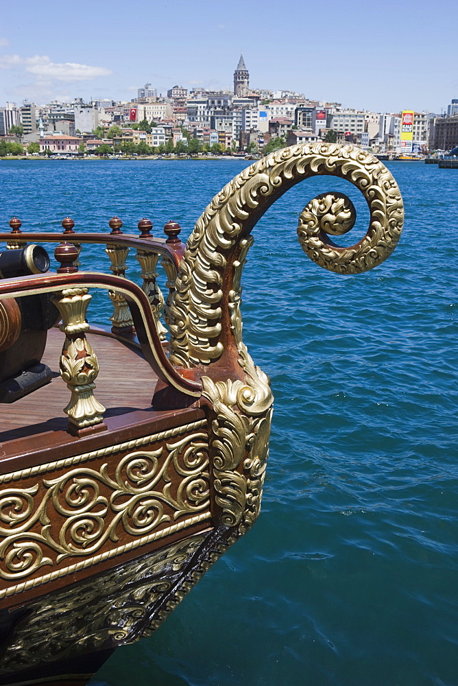 Decorative boat on the Golden Horn with the Galata Tower and Beyoglu district in the background, Istanbul, Turkey, Europe