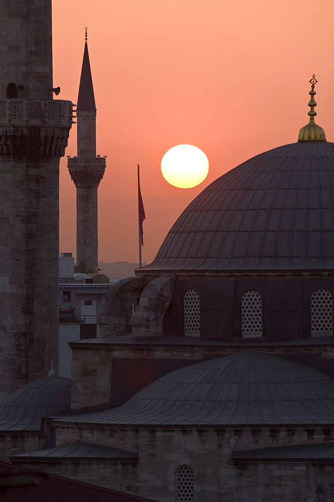 Sun setting behind Mahamut Pasha Mosque, Istanbul, Turkey, Europe