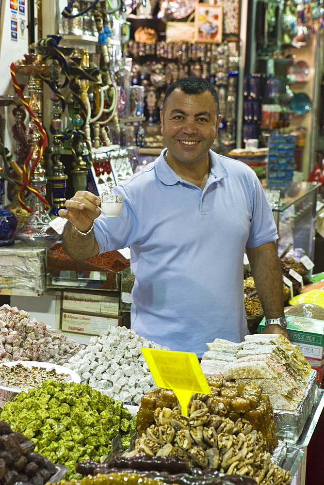 Stallholder with tea, Spice Bazaar, Istanbul, Turkey, Europe