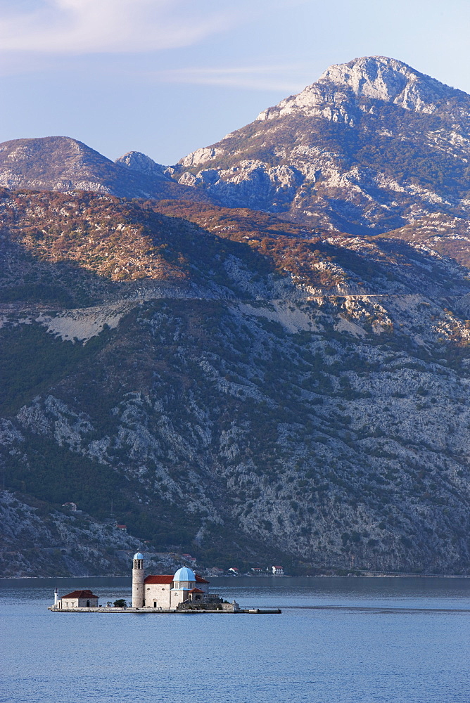 Our Lady of the Rocks island with mountains behind, on fjord near Perast, UNESCO World Heritage Site, Montenegro, Europe